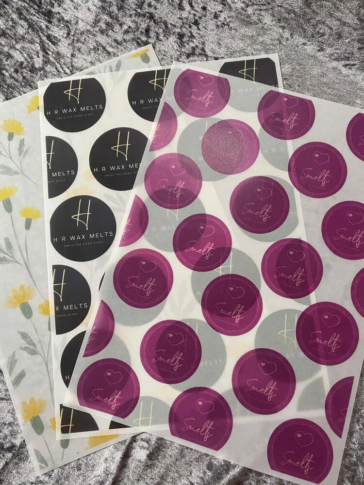 Sheets of printed vellum paper with pink and grey circular logos