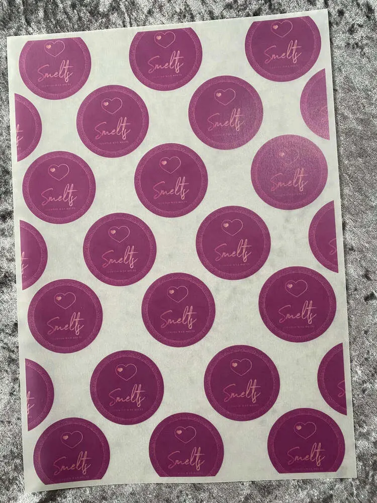 Translucent vellum sheet printed with rows of pink logo circles